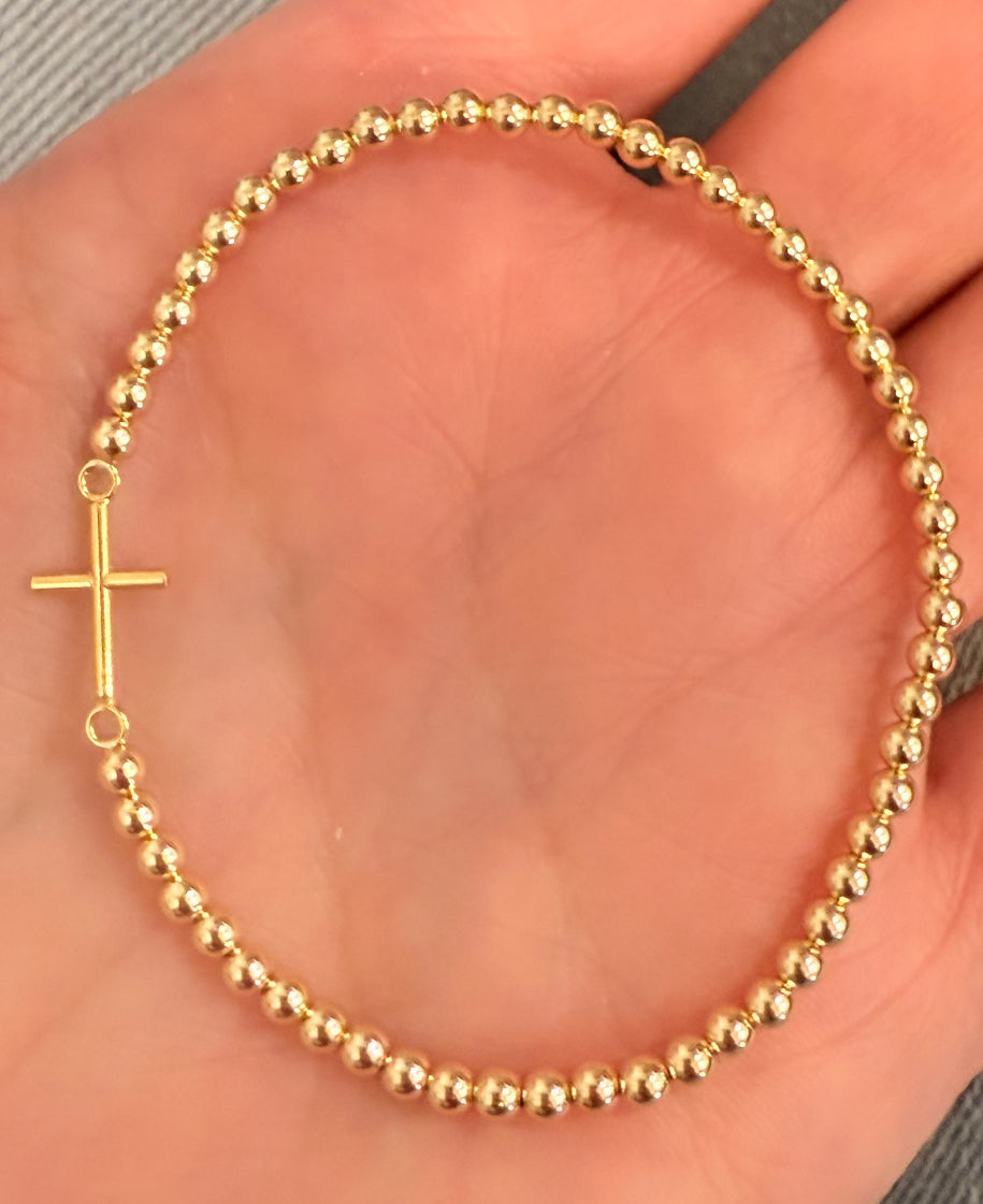 14k gold Cross detail on gold filled ball stretch bracelet