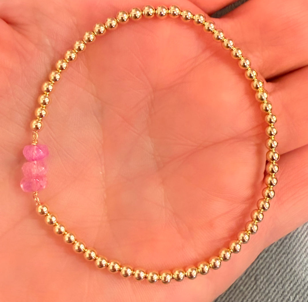 Triple stone center, pink quartz , on gold filled ball stretch bracelet
