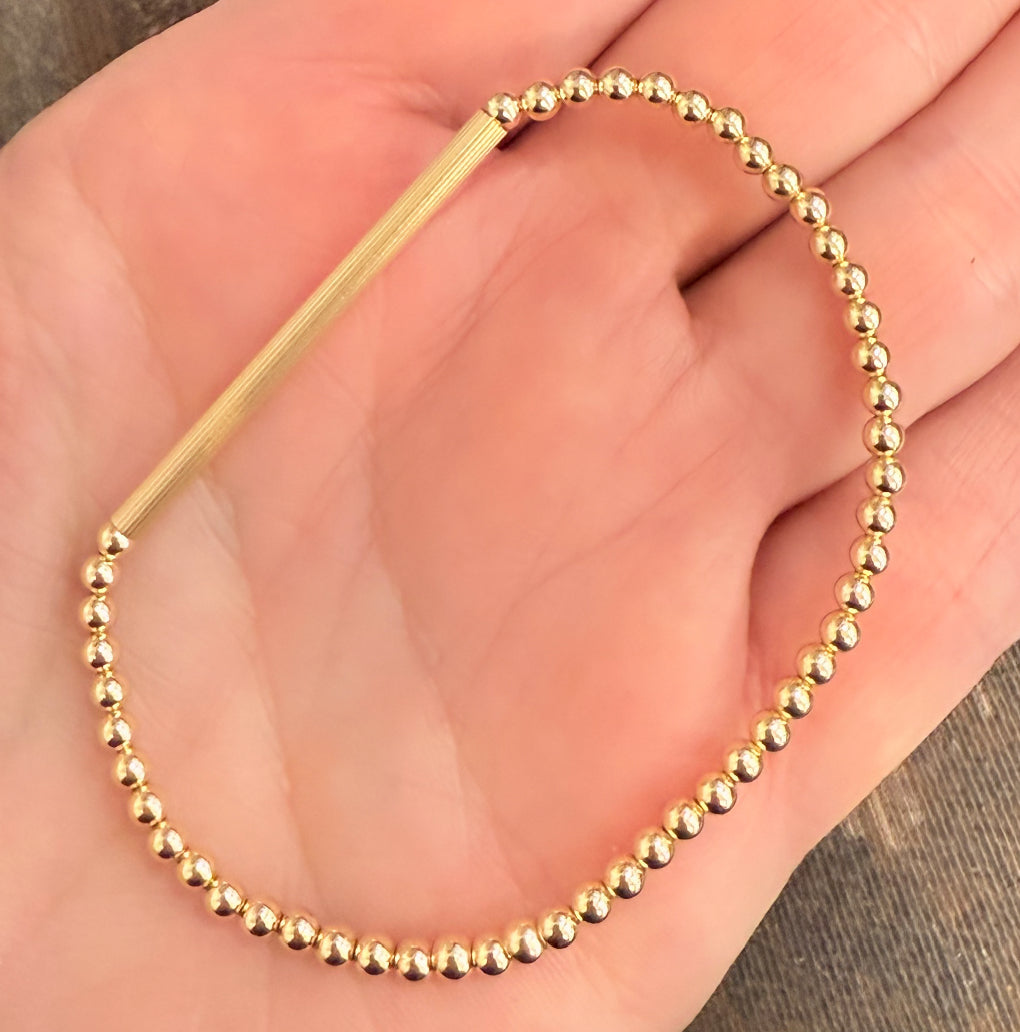 Long Corrugated bar Detail on gold filled beaded stretch bracelet