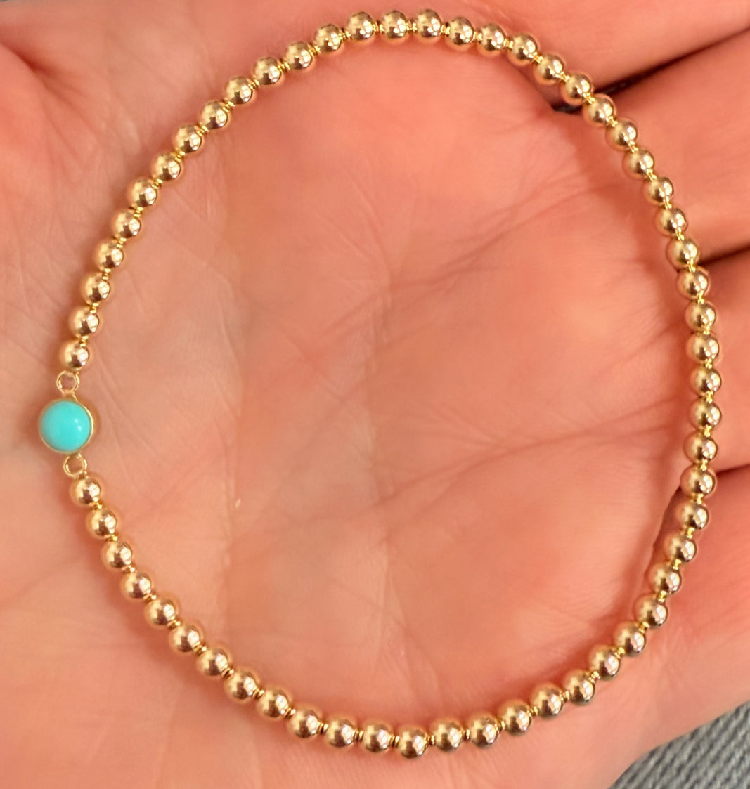 Turquoise center m, on 3mm gold filled ball, stretch bracelet