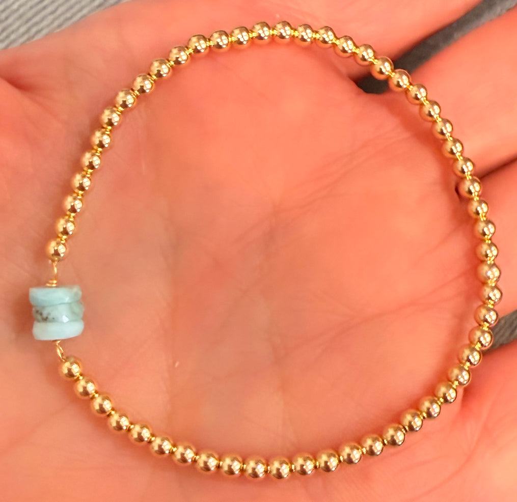 Triple stone center, larimar, on gold filled ball stretch bracelet